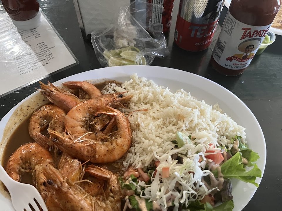 Printed menu with seafood tacos and tostadas.