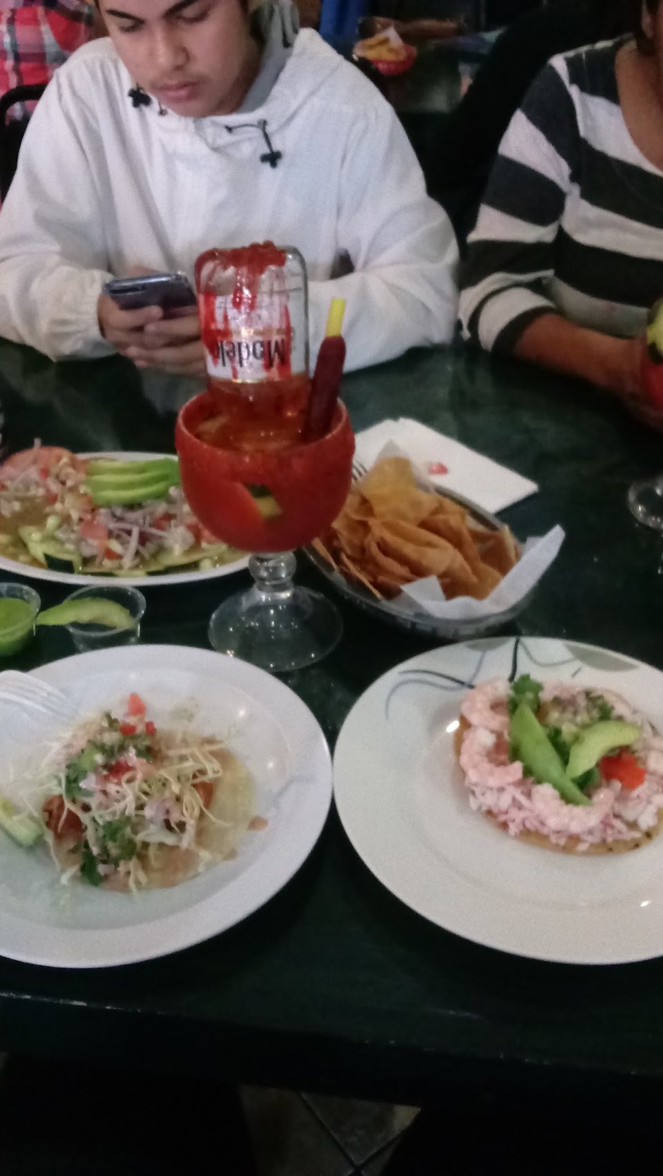 Menu board showing tacos, cocteles, and caldos.