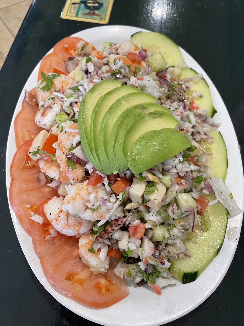 Printed menu with seafood tacos and tostadas.